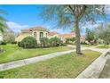 Luxury home exterior showcasing landscaping and a brick walkway at 8478 Dunham Station Dr, Tampa, FL 33647