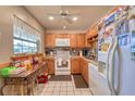 Bright kitchen with wood cabinets and white appliances at 19029 Us Highway 19 N # 3-13, Clearwater, FL 33764