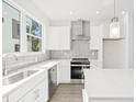 Modern white kitchen with gray tile backsplash at 319 15Th N St, St Petersburg, FL 33705