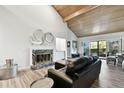 Bright living room featuring a fireplace, vaulted ceilings, and sliding glass doors at 5474 Kemkerry Rd, Wesley Chapel, FL 33543