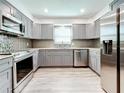 Modern gray kitchen with stainless steel appliances and granite countertops at 5529 11Th N Ave, St Petersburg, FL 33710