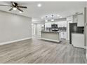 Modern kitchen with white cabinets, granite counters, and stainless steel appliances at 11650 County Road 579 Hwy, Thonotosassa, FL 33592