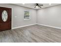 Spacious living room with gray vinyl plank flooring and ceiling fan at 11650 County Road 579 Hwy, Thonotosassa, FL 33592
