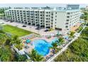 Aerial view showing condo building, pool, and surrounding area at 12000 Gulf Blvd # 309N, Treasure Island, FL 33706