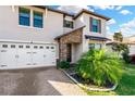 Two story house with a three car garage and landscaped lawn, close up view at 21680 Violet Periwinkle Dr, Land O Lakes, FL 34637