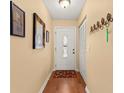 Bright entryway with wood floors and coat rack at 2750 E Bay Dr # 15E, Largo, FL 33771