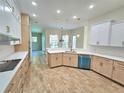 Open-concept kitchen with island and stainless steel appliances at 295 Woodstream Way, Spring Hill, FL 34608