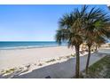 Stunning oceanfront view with sandy beach and palm trees at 3100 Gulf Blvd # 424, Belleair Beach, FL 33786
