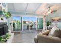 Cozy living area featuring a fireplace, sliding glass doors with water views, and dining space at 322 Windrush Blvd # 2, Indian Rocks Beach, FL 33785
