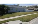 House's side yard with a well-maintained lawn and sidewalk at 5125 Silver Charm Ter, Wesley Chapel, FL 33544