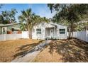 Newly renovated home with a white exterior and well-maintained lawn at 601 Paris S Ave, St Petersburg, FL 33701