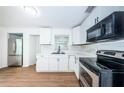 Modern kitchen with white cabinets, stainless steel appliances, and marble countertops at 601 Paris S Ave, St Petersburg, FL 33701