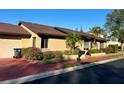 Tan house with brown roof, attached garage, and landscaping at 702 Dorado Ct, Brandon, FL 33511
