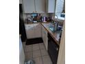 Small kitchen with white cabinets and granite countertops at 8950 Park Blvd # 505, Seminole, FL 33777