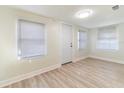 Bright living room with updated light gray vinyl flooring, fresh white paint and bright lighting at 3424 Queensboro S Ave, St Petersburg, FL 33711