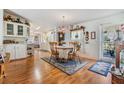 Bright dining area with wood floors, chandelier, and table with four chairs at 37340 Neukom Ave, Zephyrhills, FL 33541