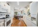 Clean kitchen with white cabinetry, laminate flooring, and ample counter space at 37340 Neukom Ave, Zephyrhills, FL 33541