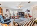 Spacious living room featuring comfortable seating, large TV, and decorative accents at 37340 Neukom Ave, Zephyrhills, FL 33541