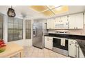 Modern kitchen with stainless steel appliances and granite countertops at 9404 Rockbridge Cir # 9404, New Port Richey, FL 34655