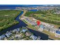 Stunning aerial view of a waterfront home with a private dock and beautiful coastal scenery at 1074 Signet Dr, Apollo Beach, FL 33572