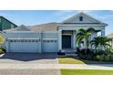 Charming single-Gathering home featuring a three-car garage and manicured landscaping in a serene neighborhood at 1074 Signet Dr, Apollo Beach, FL 33572