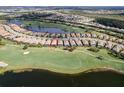 Aerial view of home on golf course with pond in luxurious community at 13118 Sorrento Way, Bradenton, FL 34211