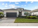 Beautiful single-story home with a dark gray garage door, tiled roof, and well-maintained landscaping at 17702 Cresswind Ter, Bradenton, FL 34211