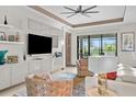 Bright living room featuring modern furniture, including a white sofa and patterned chairs at 17702 Cresswind Ter, Bradenton, FL 34211