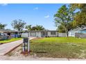 Recently updated home exterior features new paint, landscaping and a private driveway at 7812 N Woodlynne Ave, Tampa, FL 33614