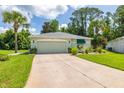 Inviting single-story home with a well-kept lawn and attached garage at 11116 Jenkins Ct, San Antonio, FL 33576