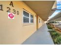 View of condo building exterior and walkway to parking at 1239 S Martin Luther King Jr Ave # 104, Clearwater, FL 33756