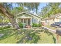 Quaint craftsman home with a large front yard and porch at 213 W Cayuga St, Tampa, FL 33603