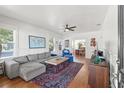 Spacious living room featuring hardwood floors, comfortable seating, and ample natural light at 213 W Cayuga St, Tampa, FL 33603