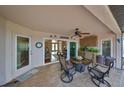 Covered patio with tile flooring, ceiling fan, outdoor seating, and views into the home's living area at 2337 Platinum Dr, Sun City Center, FL 33573