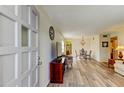 Spacious living room featuring wood-look floors and an open concept layout at 2460 Persian Dr # 26, Clearwater, FL 33763