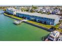 Aerial view showcasing waterfront building and boat at 250 126Th Ave # 206, Treasure Island, FL 33706