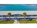 Waterfront building, aerial view, showing parking and landscaping at 250 126Th Ave # 206, Treasure Island, FL 33706