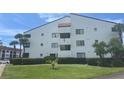 Well-maintained condo building featuring lush landscaping and a clean, bright facade at 2593 Countryside Blvd # 7213, Clearwater, FL 33761