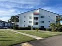 Two-story building with white exterior and palm trees at 2593 Countryside Blvd # 7213, Clearwater, FL 33761