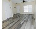 Bright living room featuring wood-look vinyl flooring at 262 Countryside Key Blvd, Oldsmar, FL 34677