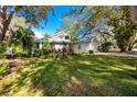 House exterior with a two-car garage and landscaping, partially visible from the side at 3003 Longbrooke Way, Clearwater, FL 33760