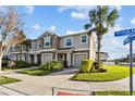 Two-story townhome with attached garage, front yard, and street view at 10405 Orchid Mist Ct, Riverview, FL 33578