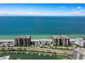 Aerial view showcasing waterfront property, boat slips, and ocean access at 1660 Gulf Blvd # 706, Clearwater Beach, FL 33767