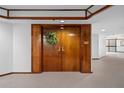Elegant entryway with double wood doors and a wreath at 1660 Gulf Blvd # 706, Clearwater Beach, FL 33767