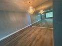 Bright living room featuring hardwood floors and a large mirror at 2460 Canadian Way # 6, Clearwater, FL 33763