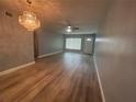 Spacious living room with hardwood floors and a chandelier at 2460 Canadian Way # 6, Clearwater, FL 33763