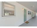 Exterior hallway of condo building featuring unit door and window at 3717 46Th S Ave # 6, St Petersburg, FL 33711