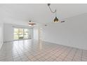 Spacious living room features tile floors and sliding glass doors to a balcony at 3717 46Th S Ave # 6, St Petersburg, FL 33711