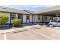 Exterior view of condo with parking and landscaping at 4925 New England Blvd # 204, New Port Richey, FL 34652