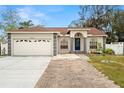 Charming one-story house with a two-car garage and nicely landscaped front yard at 5640 81St N Ave, Pinellas Park, FL 33781